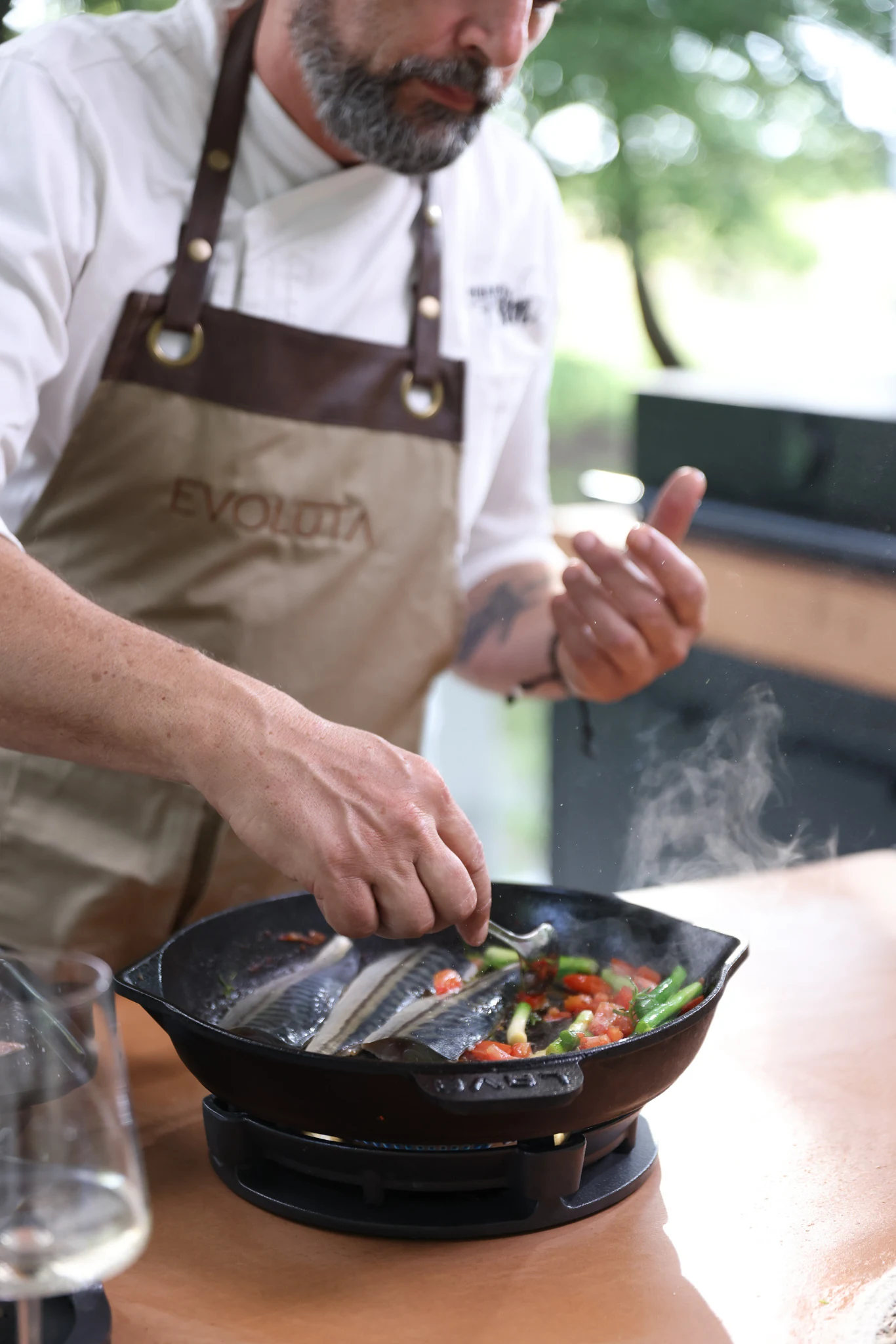 Chef cooking in an Evoluta apron during Evoluta Gourmet Experience